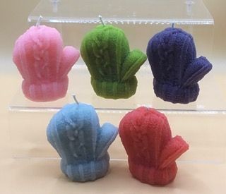 Five colorful mitten-shaped candles displayed on a clear stand.
