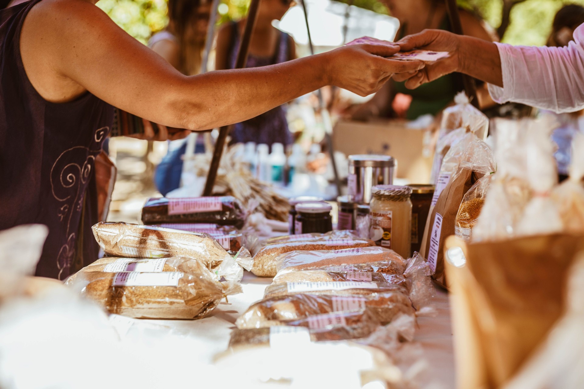 High Angle View Of People At Farmer Market Exchanging Products.